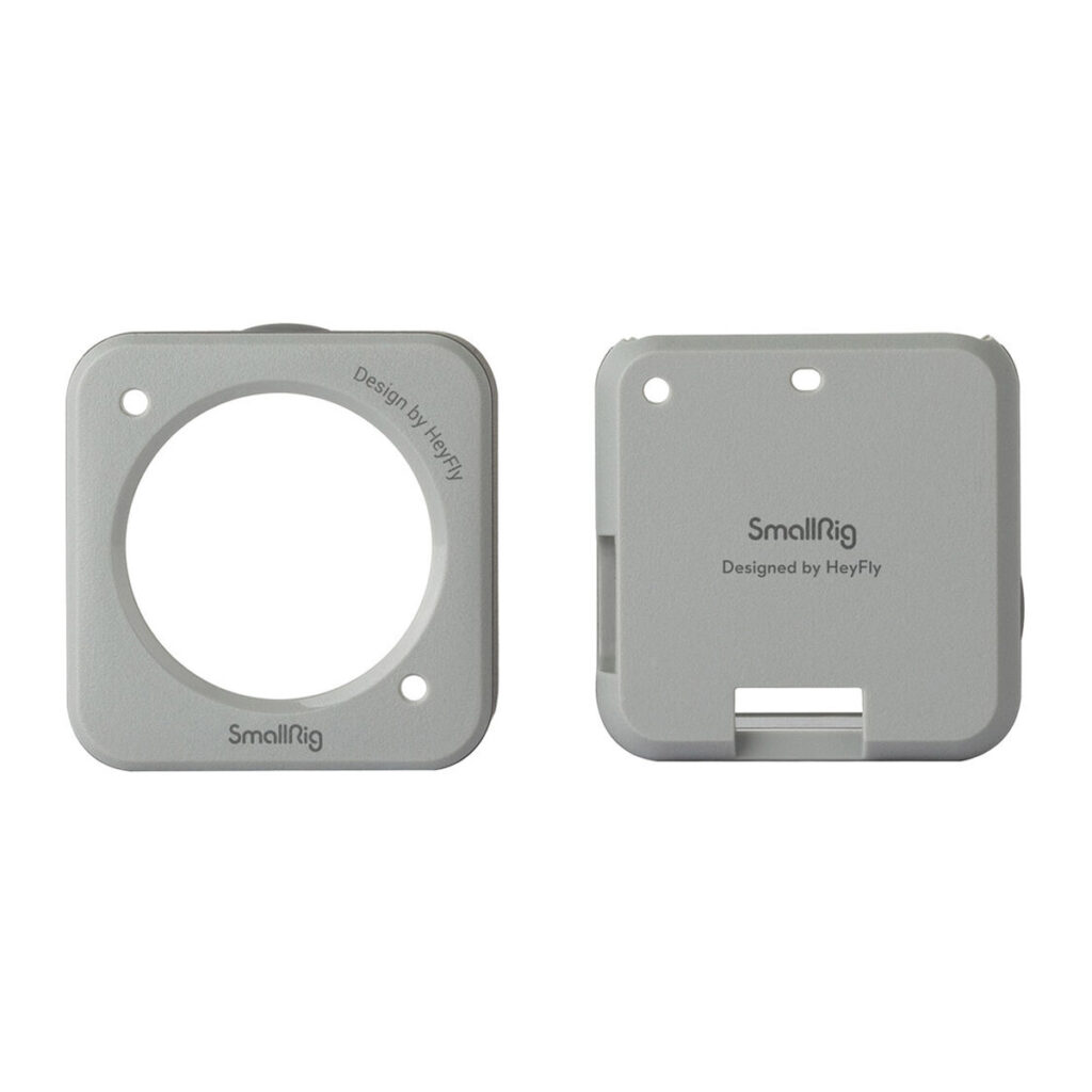 SmallRig-3627-2 Kaksi neliönmuotoista, vaaleanharmaata SmallRig 3627 Magneettikoteloa DJI Action 2:lle (harmaa) näytetään vierekkäin; toisessa on suuri pyöreä aukko, kun taas toinen on kiinteä, ja siinä on suorakulmainen aukko ja kaksi pientä reikää yläosassa.