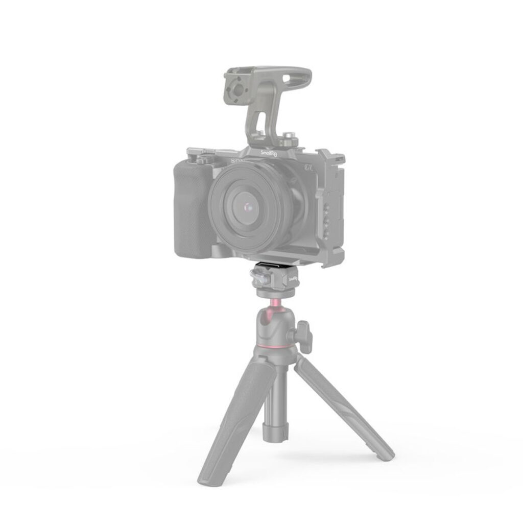 SmallRig-3730-2 SmallRig 3730 Drop-In HawkLock Mini Universal QR Top Plate näkyy selvästi valkoista taustaa vasten, ja sen päällä on himmeä digitaalikamera, joka korostaa ylälevyä pääkohteena.