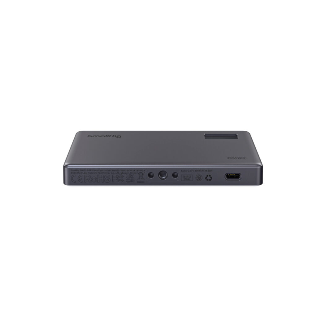 The SmallRig 3808 RGB Videolight RM120 is a compact, rectangular black device with multiple side ports, including USB-C and several circular input and output connectors, with the SmallRig logo on top.