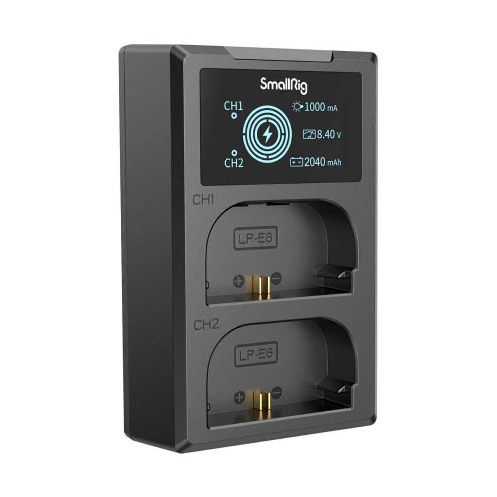 SmallRig-4084-3 The SmallRig 4084 battery charger for LP-E6 batteries is black and features an LCD display showing the charging status, two slots marked CH1 and CH2, and metal contacts for charging.