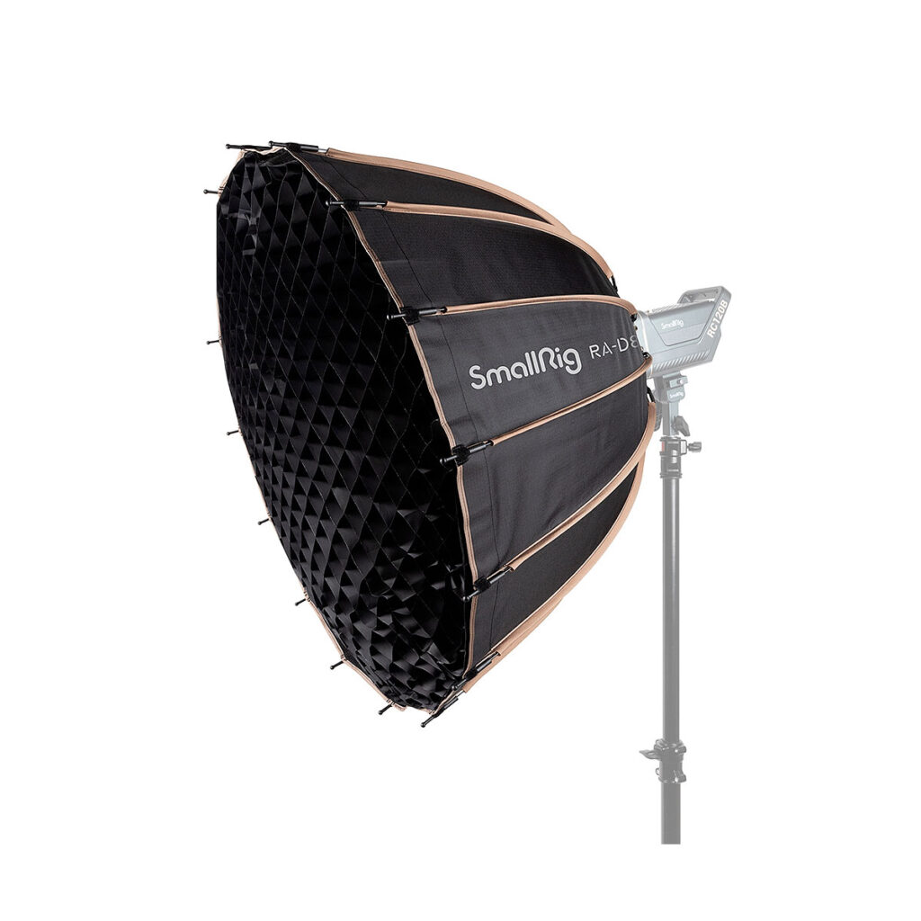 SmallRig_RA-D85_Softbox_3586_002 Musta ja kultainen SmallRig 3586 RA-D85 Parabolic Softbox, jossa on ritilä, on asennettu valotelineeseen, jossa on LED-paneeli valkoista taustaa vasten.