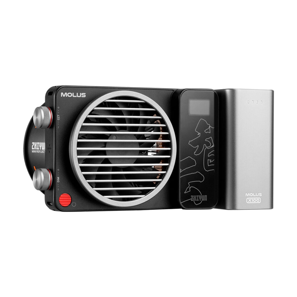 Zhiyun_Molus_X100_005 The Zhiyun LED Molus X100 COB Light Pro is a compact, rectangular black light with a front fan grill marked "MOLUS", side buttons and display, and a removable silver battery marked MOLUS X100.