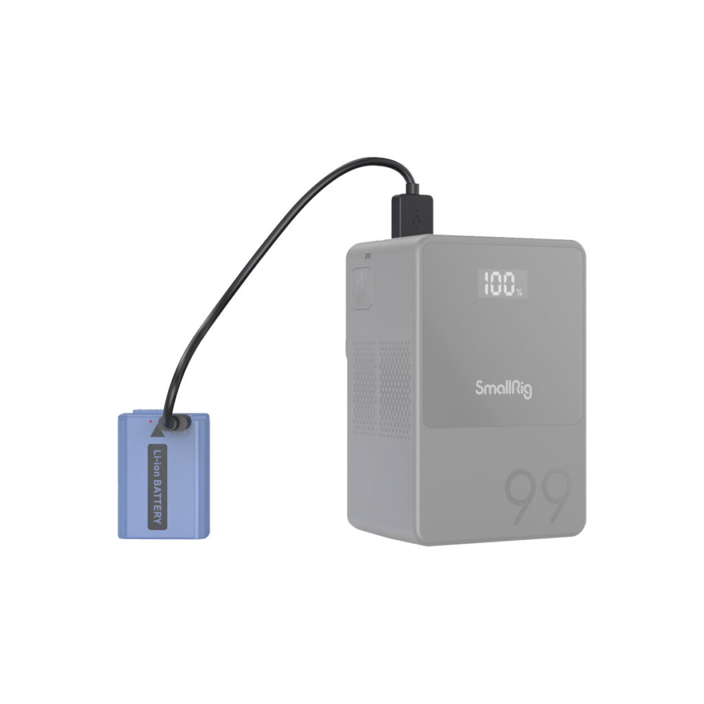 SmallRig_4330_006 Sininen Li-ion-akku liitetään mustalla kaapelilla harmaaseen SmallRig 4330 USB-C ladattavaan kameran akkuun NP-FW50, jonka minimalistiseen muotoiluun on painettu digitaalinen näyttö, jossa näkyy 100 ja numero 99.