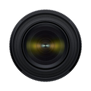 Tamron_17-50_f4_004 Close-up of the Tamron 17-50mm F/4 Di III VXD lens for the Sony E, with the lens facing forwards, showing concentric rings and reflected glass elements against a white background.