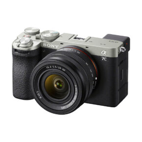 sony_a7c_ii_28-60mm_02 A silver and black Sony A7C II mirrorless camera with a 28-60mm f/4-5.6 OSS lens attached, shot from the front on a white background.