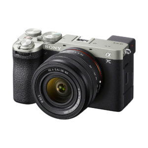 A silver and black Sony A7C II mirrorless camera with a 28-60mm f/4-5.6 OSS lens attached, shot from the front on a white background.