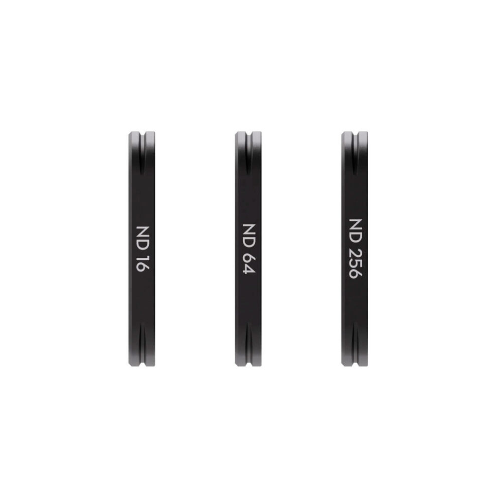 DJI_Osmo_3_008 Three thin, round DJI Osmo Pocket 3 magnetic filters (ND 16, ND 64 and ND 256) stand vertically next to each other on a white background.