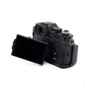 Fuji X-T3 + kahva-3 Fujinon GF 50mm f/3.5 R LM WR (sis.ALV24%) - Käytetty -objektiivi on kuvassa kiinnitettynä mustaan digitaalikameraan takaa katsottuna, LCD-näyttö on käännetty ulos ja ohjauspainikkeet näkyvät rungossa.