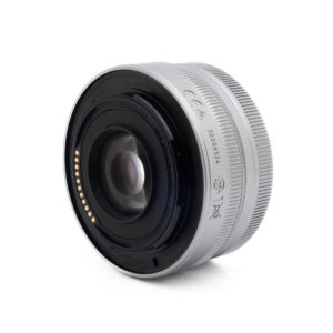 Nikon Z DX 16-50mm f35-63-1-2 Lähikuva Fujinon GF 50mm f/3.5 R LM WR (sis.ALV24%) - Käytetty -objektiivista valkoisella taustalla, jossa korostuvat sen lasielementit ja elektroniset kontaktit takakiinnikkeessä.