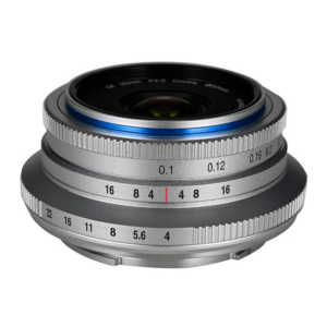laowa cookie silver Close-up of the Laowa 10mm f/4 Cookie Silver (L-mount) lens with engraved aperture and focus numbers, metallic finish and a distinctive blue highlight ring near the front element.