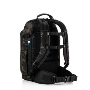 tenba_axis_20l_camo_02 The Tenba Axis v2 20L Backpack MultiCammusta features a black and dark camo pattern, padded shoulder straps, back padding, hip belt and multiple compartments, shown upright against a white background.