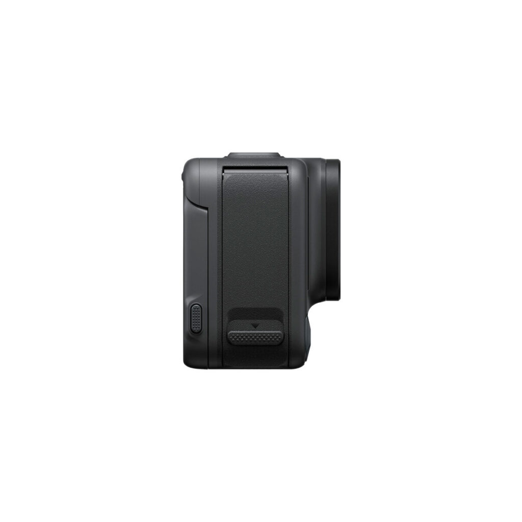Insta360_Acepro_007 The side view of the Insta360 Ace Pro 8K Action Camera shows its textured grip, small button near the bottom and flat rectangular panel. The dark grey camera body has a slightly protruding lens on the right side.