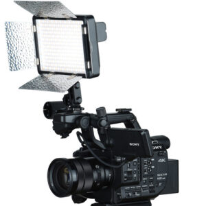 1579519631_342 Ammattikäyttöön tarkoitettu Godox Led LF308BI -paneelivalaisin lato-ovilla, joka on asennettu Sonyn 4K-videokameraan, jossa on erilaisia ohjauspainikkeita, zoom-objektiivi ja sivukahva.