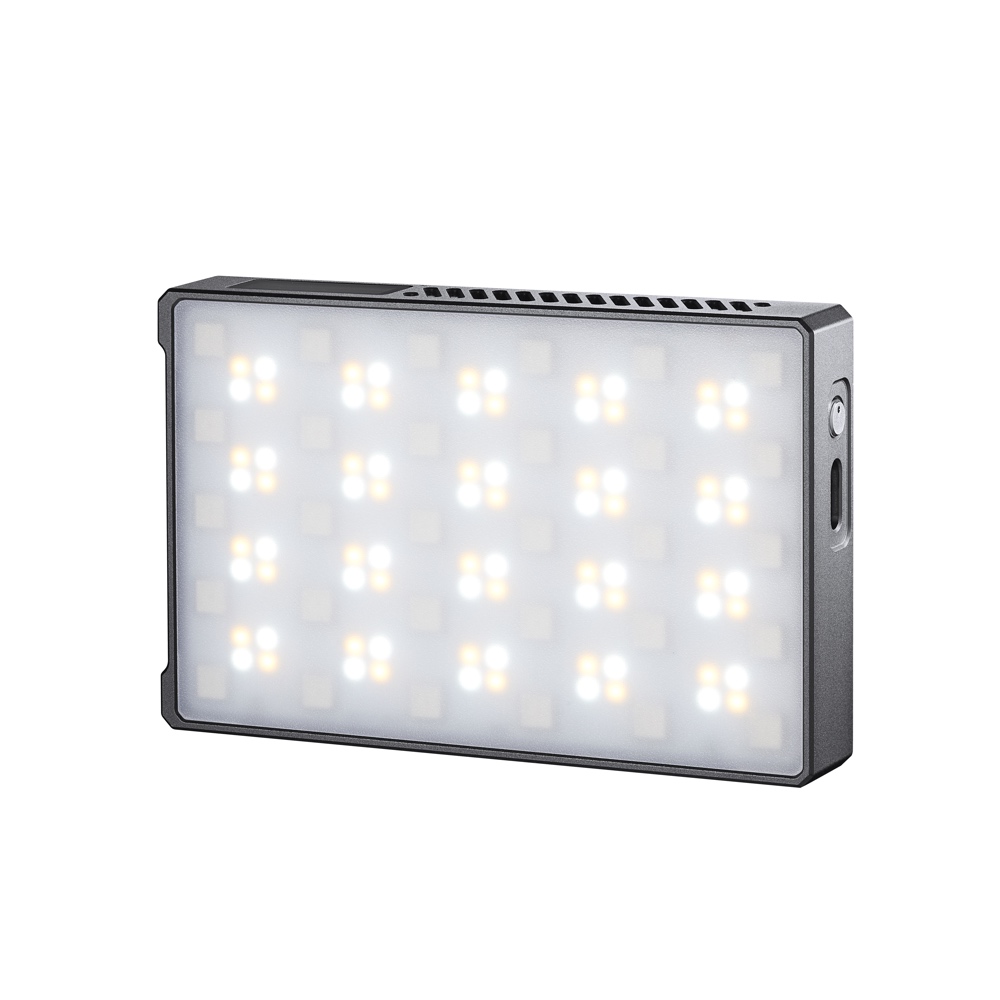 1668085475_779 Godox C5R Mobile RGB LED -valaisimessa on ohut, metallinen suorakulmainen kotelo, jossa on pyöristetyt reunat, sivupainike ja kirkkaiden valkoisten ja keltaisten LED-valojen verkko.