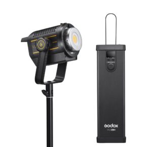 1675094453_738 The Godox VL200II LED video light is mounted on a stand, and next to it is a rectangular black external control unit with a display and selector, both with yellow highlights.