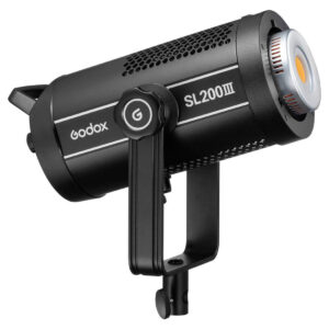 1675234816_711 The Godox SL200III LED video light in black, with a cylindrical body, cooling vents and mounting bracket, is presented at a three-quarter angle to the right.