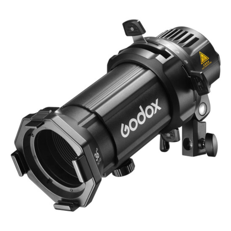 Godox Spotlight Attachment MLP36K ML30/ML60 LED-valoille on musta sylinterinmuotoinen projektorin lisävaruste, jossa on säätönupit, kiinnityskannatin ja varoitustarra.