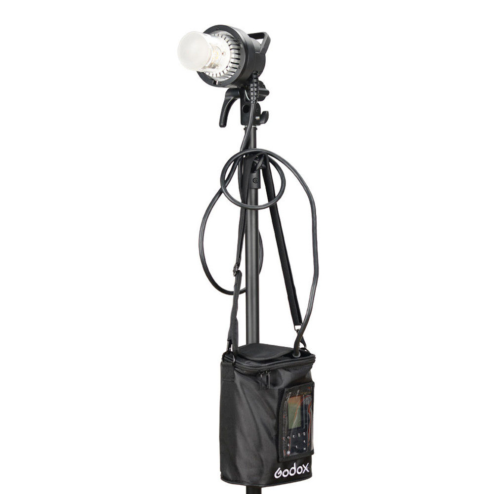 1560261311_816 Studio light with stand with cables and black Godox PB-600P Portable Bag for AD600Pro with transparent window and zippered flap attached under the light.