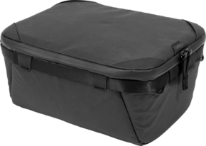 800q-01_125231 The Peak Design Camera Cube V2 (S-Medium) is a black, rectangular travel bag with slightly rounded corners, smooth fabric construction, zipper and small side handles.