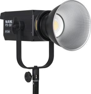 800q-02_119722 The NANLITE FS-300B LED Bi-color Spot Light is mounted on a black base with a large silver reflector and a bright central LED set against a white background.