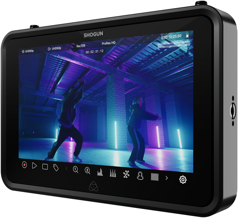 ATOMOS SHOGUN 7-tuumainen HDR-monitori-tallennin 6K RAW näyttää kaksi ihmistä tanssimassa hämärästi valaistussa teollisessa tilassa, jossa on violetteja ja sinisiä neonvaloja, ja kameran ja tallennusliittymän kuvakkeet näkyvät näytöllä.