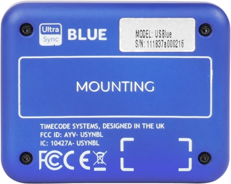 800q-05_121975 ATOMOS Ultrasync Blue on sininen laite, jonka takapuolelle on painettu asennusohjeet, säädöstiedot, malli- ja sarjanumerot sekä FCC-tunnus. Timecode Systems on suunnitellut sen Yhdistyneessä kuningaskunnassa.