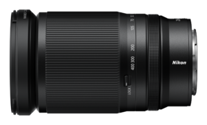 Z28-400_4-8_angle4_0 Musta Nikon Nikkor Z 28-400mm f/4-8 VR -objektiivi, jossa on zoomausmerkinnät, kuvioitu kahva, lukituskytkin ja Nikonin tuotemerkki sivulla, näkyy valkoisella taustalla.