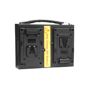 nanlaturi1 The NANLITE Battery Charger for Dual 26V V-mount battery is a black portable charger with a handle, two battery slots and a yellow warning label on the front that reads "Charge 26V battery only!".