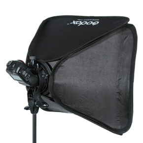 Godox S-tyypin Bracket Bowens + Softbox 60x60cm, kuvassa asennettuna salaman kanssa valotelineeseen, tarjoaa ammattimaisen mustan softbox-valaistuksen valokuvaukseen.