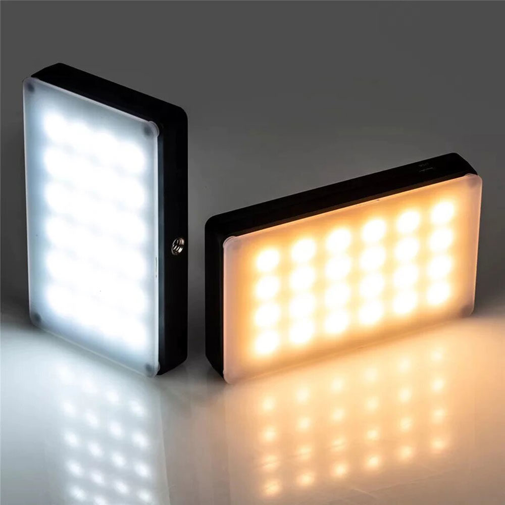 1562766649_240 Kaksi Viltrox RB08 LED-valopaneelia näytetään vierekkäin heijastavalla pinnalla harmaata taustaa vasten - toinen antaa kirkkaan valkoista valoa ja toinen lämpimän keltaista valoa.