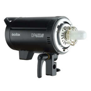 1582637384_756 The Godox DP600III, a black studio strobe with a visible flash tube, is mounted on a swivel mount and displayed against a white background.