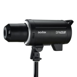 1582637388_517 Mustaksi viimeistelty Godox DP600III -studiostroboskooppivalaisin on asetettu jalustalle vasemmalle päin, ja sen kyljessä näkyy tuotemerkki ja mallin nimi.
