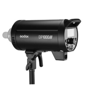 1594299372_788 The black Godox DP1000III studio strobe is mounted on a light stand, with its control panel, power buttons and rear display clearly visible.