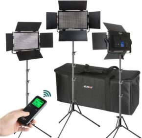 1608189174_443 The Viltrox VL 40T LED Light Triple Kit includes three professional panel lights with barn doors on adjustable stands, a handheld remote control and a black carrying case - ideal for portable photography or video lighting.