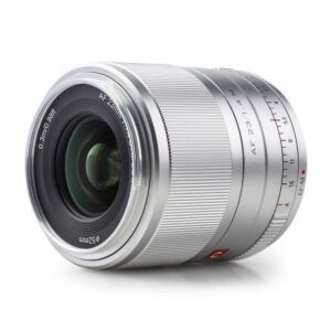 1625752386_677 The Viltrox AF 23mm f/1.4 lens for Fuji X (silver) features a grooved focus ring, visible glass, engraved 23mm focal length, aperture settings and 52mm filter size, shown against a white background.