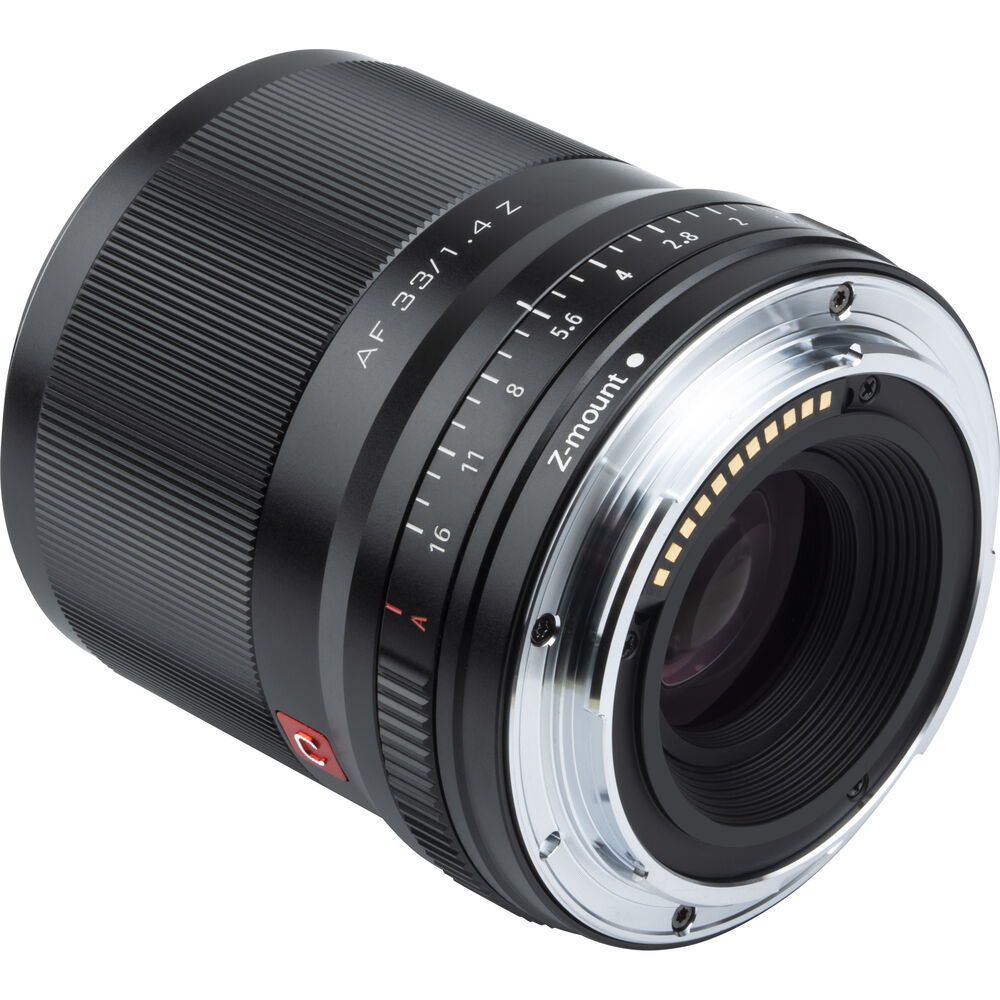 Nikon Z:lle tarkoitetun Viltrox AF 33mm f/1.4 -objektiivin lähikuvassa näkyy sen musta tynnyri, hopeinen metallinen kiinnitys, aukon merkinnät ja tarrat elektronisten koskettimien lähellä.