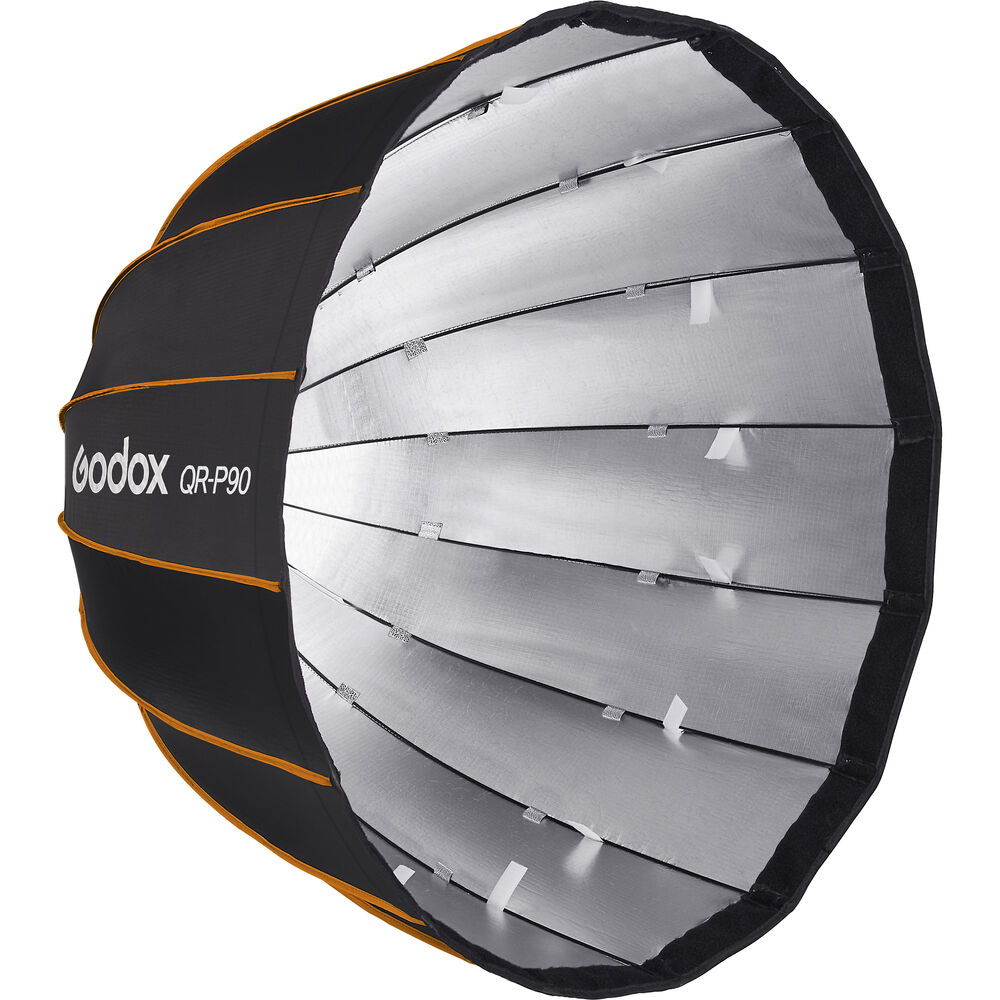 1646908705_058 Suuri, pyöreä, musta-hopea Godox Quick Release Parabolic Softbox QR PF90 Profoto, jossa on oranssi reunus ja uurrettu rakenne, joka on suunniteltu hajottamaan valoa valokuvaukseen tai videokuvaukseen.