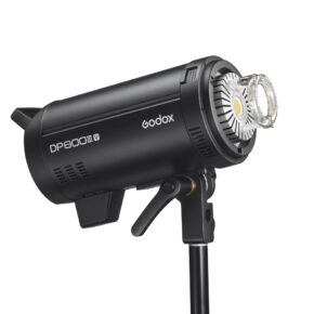 1656492117_590 The black Godox DP800III-V studio strobe lamp is mounted on a tripod and is visible in profile, with its LED and reflector visible.