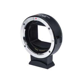 The Viltrox EF-L Auto Focus lens mount adapter, with black and silver electronic contacts, stands upright on a small tripod against a white background.