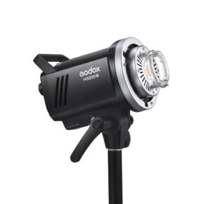 Musta Godox MS200V -studiostroboskooppivalaisin on asennettu valotelineeseen, hieman ylöspäin taivutettuna, ja siinä on näkyvät säätimet ja pyöreä salamaputki edessä.