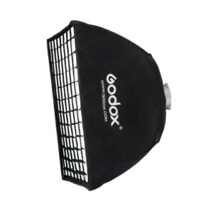 The Godox Softbox Bowens Mount + Grid 60x60cm is shown against a white background, with the Godox brand and website displayed on the black surface, and its grid mount is visible for studio lighting use.