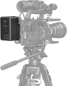 SmallRig_4293_003 A professional video camera on a tripod with a SmallRig 4293 V-Mount battery VB212 Mini x Caleb Pike attached to the side, connected with several cables.