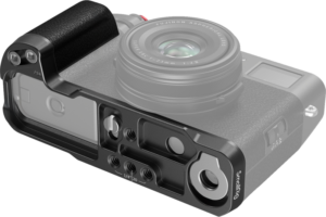 SmallRig_4556_003 SmallRig 4556B L-shaped grip for Fujifilm X100VI/X100V (black) with various cut-outs, mounting holes and textured grip, attaches to the base of a semi-transparent mirrorless camera with lens.