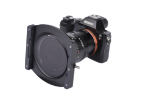 800q-01_113503 The Nisi Filter Holder for Laowa 12mm f/2.8 is attached to a digital camera lens against a white background.