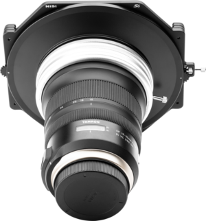 The NiSi Filter Holder S6 Kit True Color for Tamron 15-30mm f/2.8 is shown mounted on a Tamron lens with the lens cover against a light grey background.