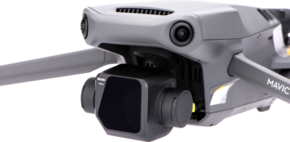 800q-01_118281 A close-up of the Nisi Filter For Mavic 3 ND64 filter attached to a grey DJI Mavic drone, highlighting its camera gimbal and front sensors against a white background.
