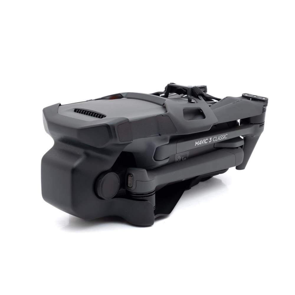 DJI Mavic 3 Classic-1 Taitettu musta DJI Mavic 3 Classic + RC Ohjain - Käytetty -lennokki näkyy edestäpäin valkoisella taustalla, ja sen käsivarret ja potkurit on laitettu siististi sisään.