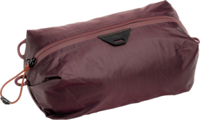 800q-01_128356 The Peak Design Ultralight Packing Cube X-Small Eclipse is a brown and yellow rectangular bag with a black triangular logo near the zipper, orange drawstring, side handles, and is made of lightweight, water-resistant fabric.