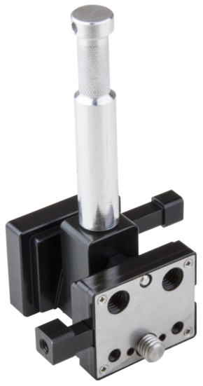 800q-01_122868 The Kupo KS-275 Dual V-Lock Adapter is a metal and black plastic component with a cylindrical handle, square base, front plate with screw holes and two round slots.