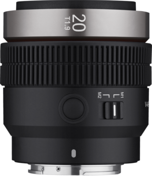 800q-01_127883 A close-up of the Samyang V-AF 20mm T1.9 - Sony FE lens shows the black grooved focus rings, the metal mount and the side switch marked M1 M2.
